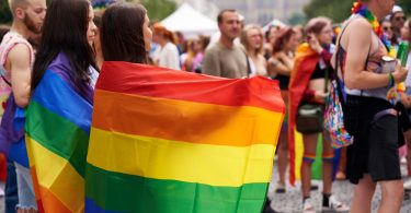 LGBT women with colorful rainbow flags at the Wenceslas square during gay pride